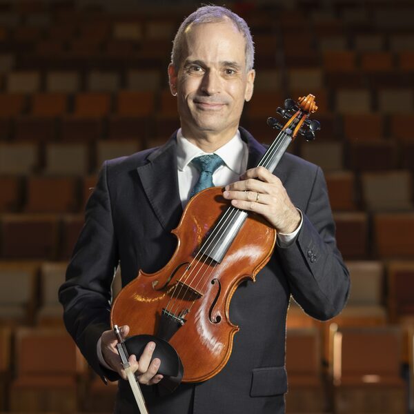 Dr. Zoltan Paulinyi, violinist and teacher, posing with his viola pomposa